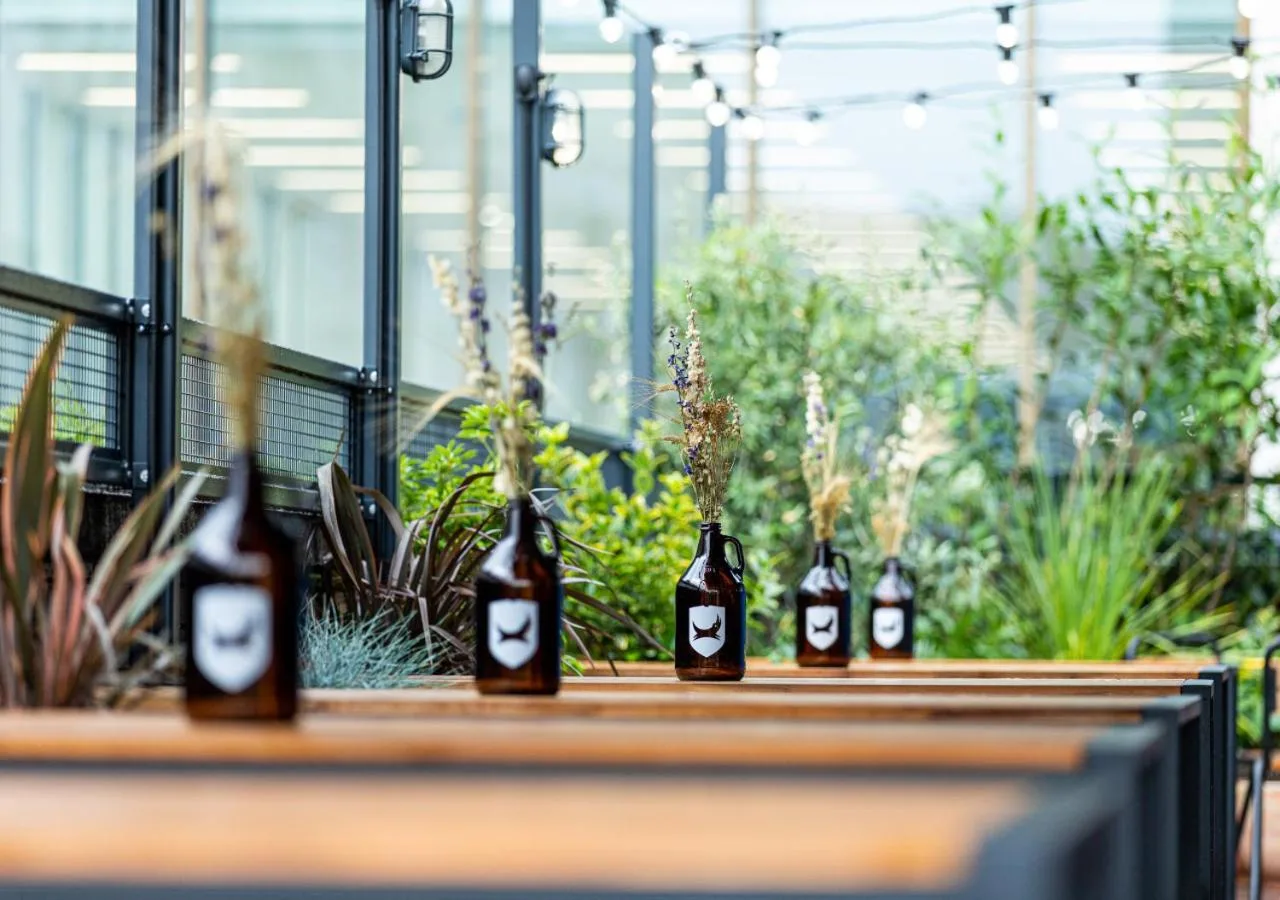 four bottles of wine sitting on a table in a greenhouse at BrewDog DogHouse Manchester in Manchester